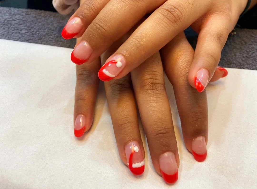Coral red manicure with accent nail art